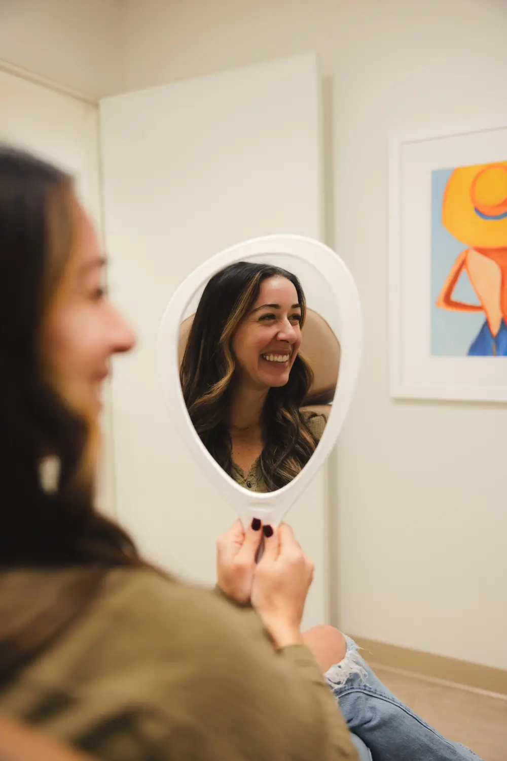 Patient checking results in mirror after Botox treatment